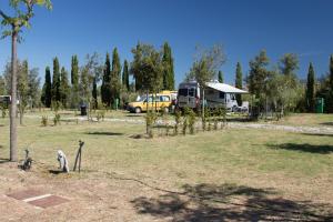 a campsite with a camper and a yellow van at Agricampeggio Ippocampo in La Cinquantina +105 photos