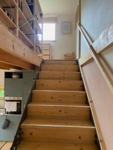 a staircase in a house with wooden steps at Cottage by the Jizera river in Nový Vestec