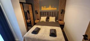 a pair of beds in a room with mirrors at Koneser Warsaw by Better Place in Warsaw
