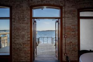 an open door with a view of the water at The Belmont Hotel in Port Townsend +6 photos
