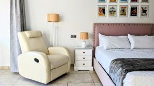 a bedroom with a chair next to a bed and a chair at I love Marina Greenwich, Altea in Altea +88 photos