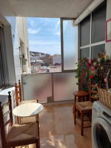 a balcony with a washing machine and a table and chairs at Apartamento en Alicante, Plaza de España, zona Mercado, AA in Alicante +64 photos
