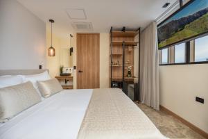 A bed or beds in a room at LIN Boutique Hotel by HOUSY HOST
