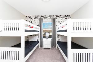 a bedroom with two bunk beds and a window at 4BD/3BA Champions Gate Home With Private Pool in Davenport +40 photos