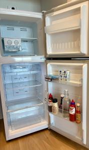 an open refrigerator with its door open and its contents at Stunning Apt central to Canberra & surrounds in Phillip +8 photos