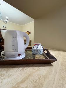 a white coffee maker on a tray on a counter at Mavianto in Torre le Nocelle