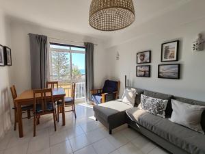 a living room with a couch and a table at 4C Atlantico 1 - Casas & Papeis in Armação de Pêra