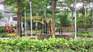 a playground with a slide in a park at BassuraCity Apartment near Hi-Speed Train Station -Min Stay 3 nights- in Jakarta
