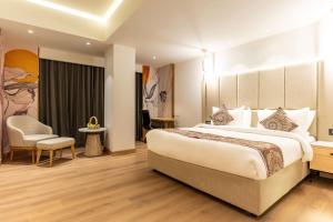 a hotel room with a large bed and a chair at Best Western AH1 Amritsar in Amritsar