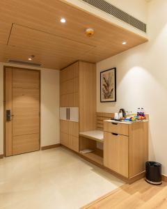 a room with a sauna with wooden cabinets and a door at Best Western AH1 Amritsar in Amritsar