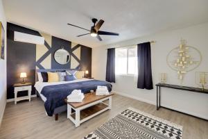 a bedroom with a blue bed and a ceiling fan at Mtn-View Home about 8 Mi to Joshua Tree Natl Park! in Joshua Tree