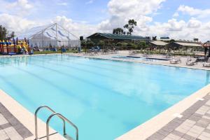 a large pool with blue water in a resort at MILANY HOMES - near JKIA AIRPORT and SGR TRAIN station in Nairobi