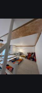 two bunk beds in a room with a ladder at Joli studio centre-ville Caen in Caen
