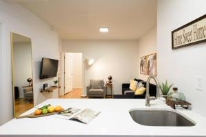 a kitchen with a sink and a living room at 109-1 Huge 3BR Best Value - NYC Apt in New York