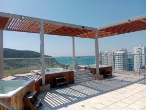 a deck with a hot tub and a hot tub at APARTAMENTO EN GAIRA PLAYA SALGUERO SANTA MARTA in Gaira