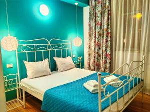 a bedroom with a bed with a blue wall at CoZy Apartments in Timişoara