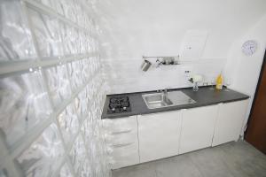a kitchen with a sink and a counter top at Casa Sant Anna in Naples