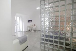 a room with a wall of glass bottles at Casa Sant Anna in Naples