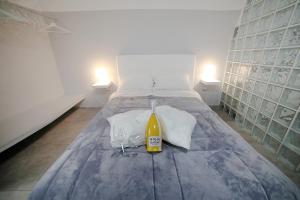 a bedroom with a bed with a bottle and towels at Casa Sant Anna in Naples