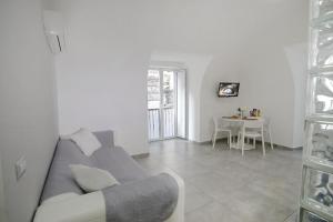 a living room with a couch and a table at Casa Sant Anna in Naples