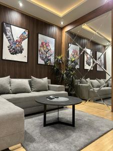 a living room with a couch and a table at Modern Luxury in Belgrade Waterfront with Views in Belgrade