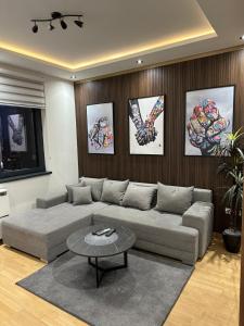 a living room with a couch and a table at Modern Luxury in Belgrade Waterfront with Views in Belgrade