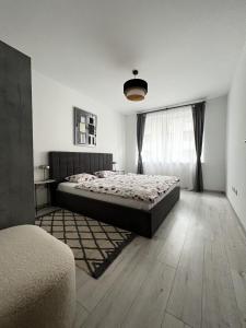 a bedroom with a bed and a large window at MT Suites ApartHotel in Budapest