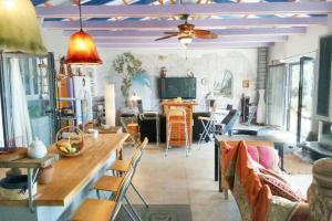 a living room with a table and chairs and a tv at Elegant Villa with Sea View in Politika in Politiká
