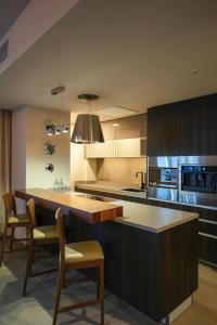 a kitchen with a large island in the middle at Metria Hotel in León