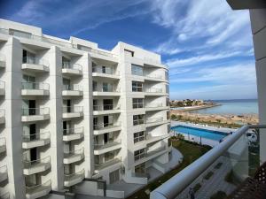 a white building with a view of the ocean at Scandic resort in Hurghada