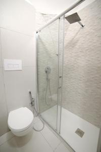 a white bathroom with a shower and a toilet at Casa Sant Anna in Naples