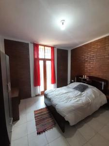 a bedroom with a large bed and a window at Complejo Don Tito in San Juan +70 photos