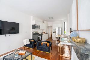 a living room with a kitchen and a living room with a table at 1288-3RN New Renovated 1 Bedroom in UES in New York