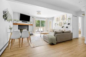 a living room with a couch and a table and chairs at Bright & Modern - King Suite - Creekside Trail in Boulder