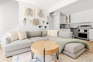 a living room with a couch and a table at Bright & Modern - King Suite - Creekside Trail in Boulder +32 photos