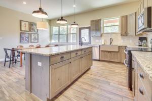 a large kitchen with wooden cabinets and a large island at Scenic Views, Fire Pit Texas Hill Country Getaway in Fischer