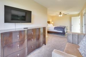 a bedroom with a dresser with a tv on the wall at Scenic Views, Fire Pit Texas Hill Country Getaway in Fischer