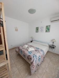 En eller flere senge i et værelse på Departamento Marusa