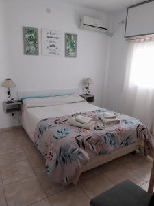 En eller flere senge i et værelse på Departamento Marusa