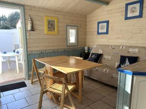 a room with a table and a bed with boxes at Maison rénovée proche mer avec piscine chauffée, tennis, WiFi, parking privé - Bretignolles-sur-Mer - FR-1-224A-72 in Brétignolles-sur-Mer +13 photos