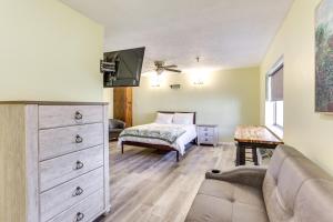 a bedroom with a bed and a dresser with a couch at Quiet Oakland City Studio Walk Downtown! in Oakland City