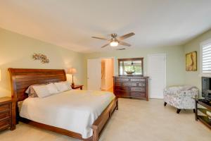 a bedroom with a bed and a ceiling fan at Key Largo Getaway with Bay Views and Pool Access! in Key Largo +21 photos
