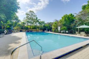 a swimming pool at a resort with tables and chairs at Key Largo Getaway with Bay Views and Pool Access! in Key Largo