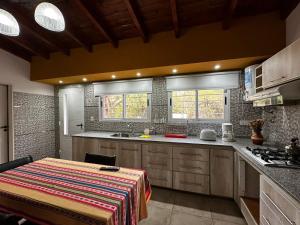 a kitchen with wooden cabinets and a counter top at Cabañas El Maiten in Merlo +45 photos