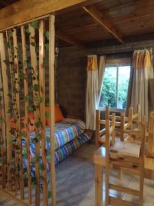 a bedroom with a bed in a wooden house at Amistad in Villa Gesell