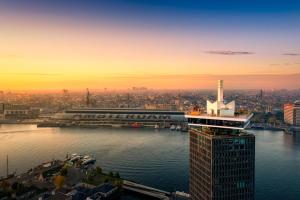 a view of a city with a river and a building at Hilton Amsterdam Airport Schiphol in Schiphol