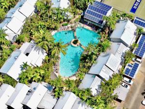 an overhead view of a pool with palm trees and solar panels at Coastal Modern 3 Bedroom Townhouse in Noosaville