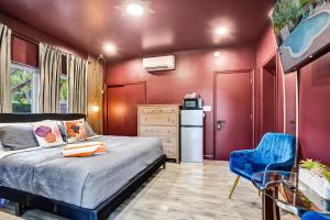 a bedroom with a bed and a blue chair at Kiki 5 - Men's Clothing optional Guest Houses in Fort Lauderdale