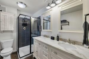 a bathroom with a toilet and a sink and a shower at Hot Tub, Fire Pit, Dog Friendly, Heart of Sisters, Amenities in Sisters +46 photos