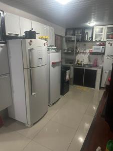 a kitchen with three refrigerators in a room at COP 30 - casa região metropolitana in Ananindeua